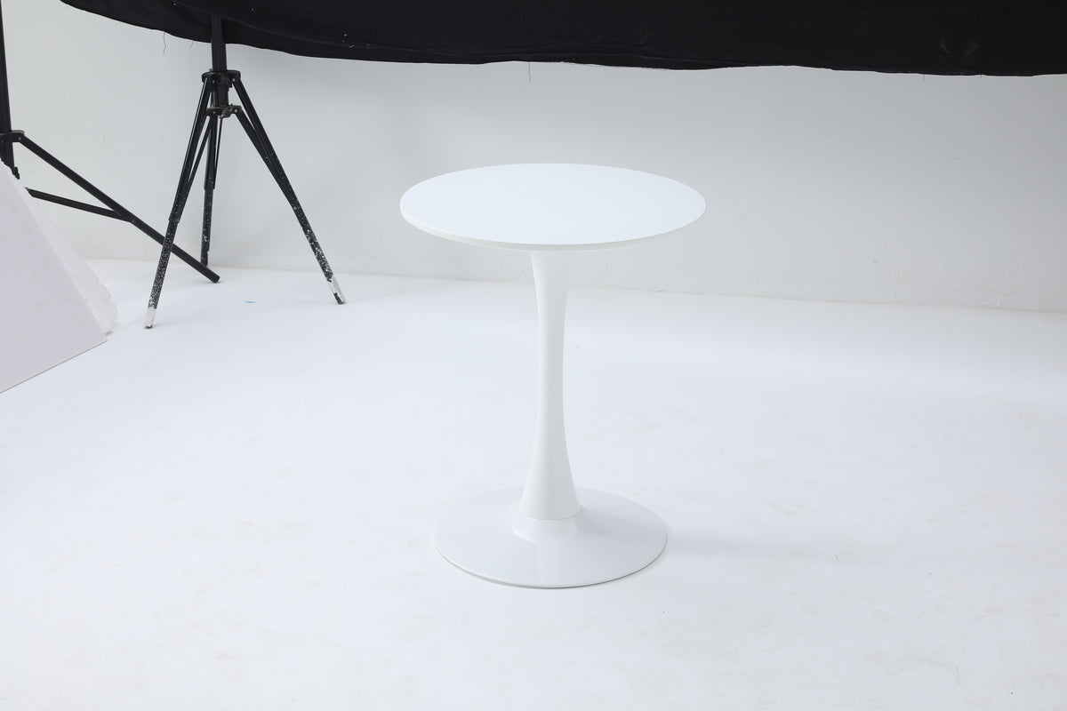 White round tulip bistro table alone in a photo studio with backdrop and tripod visible