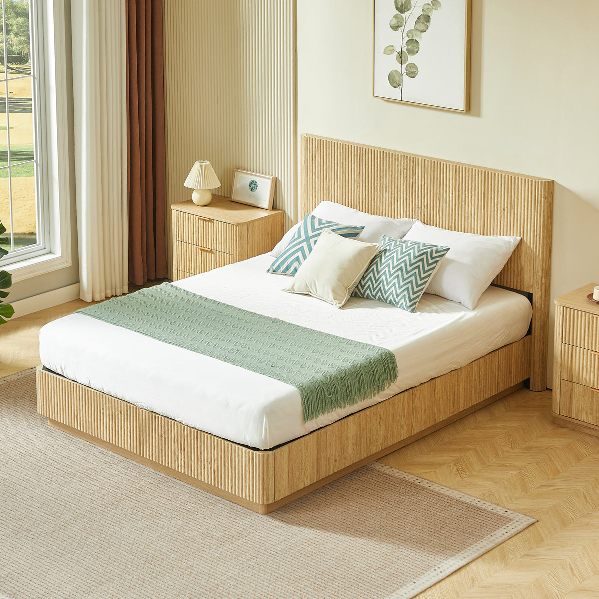 Foot-angle view of light oak fluted queen bed by a window with golf course view and nightstand