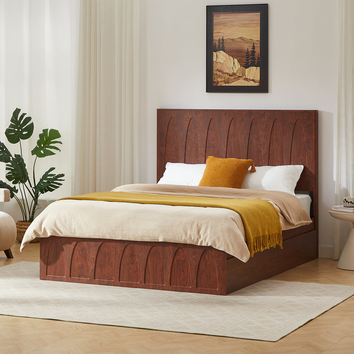 Angled view of dark reddish-brown wood queen bed, drawers closed, white and mustard bedding, potted plant