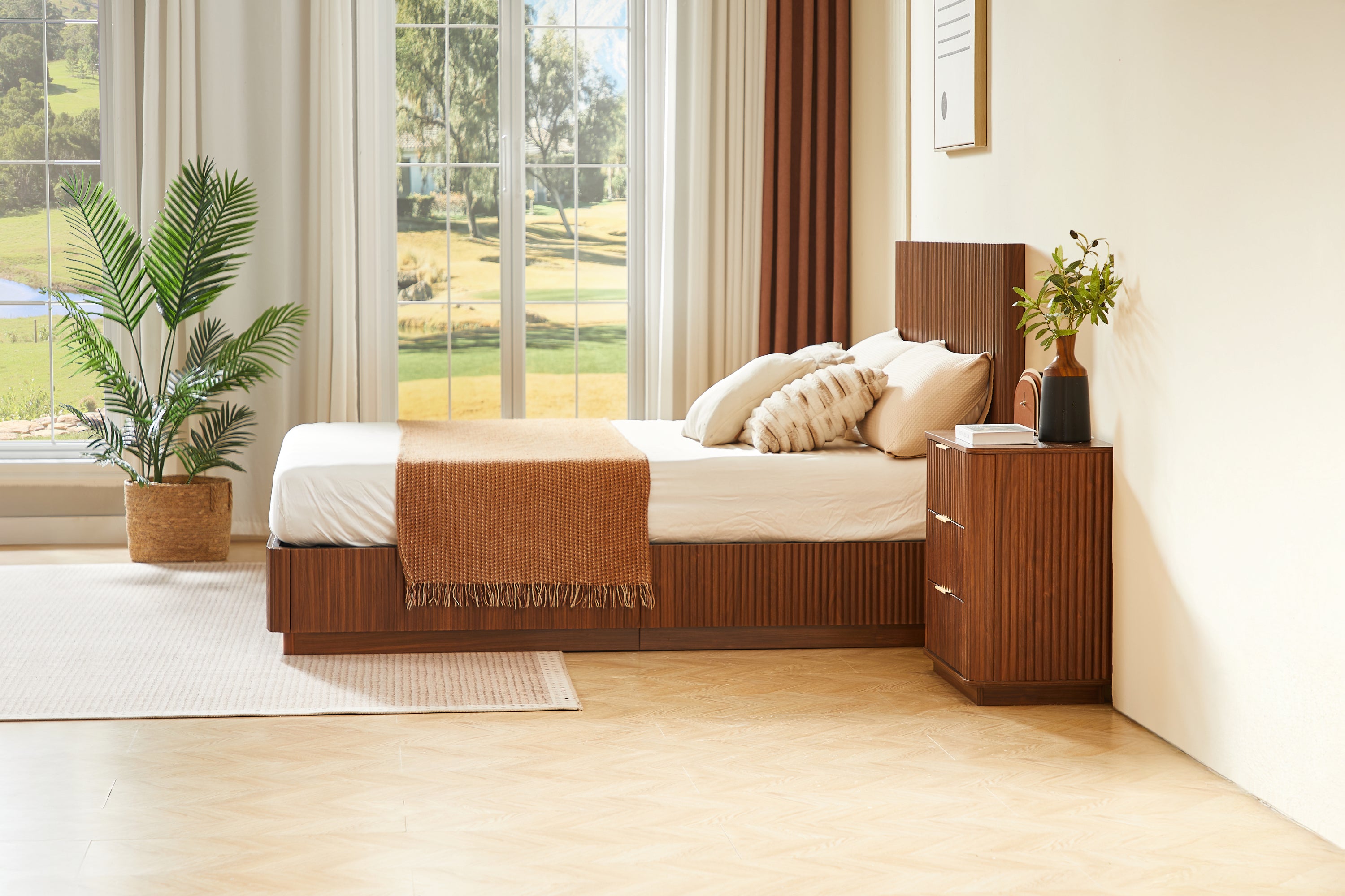 Side-angle room view of the low walnut platform bed by a large window #Color_Walnut