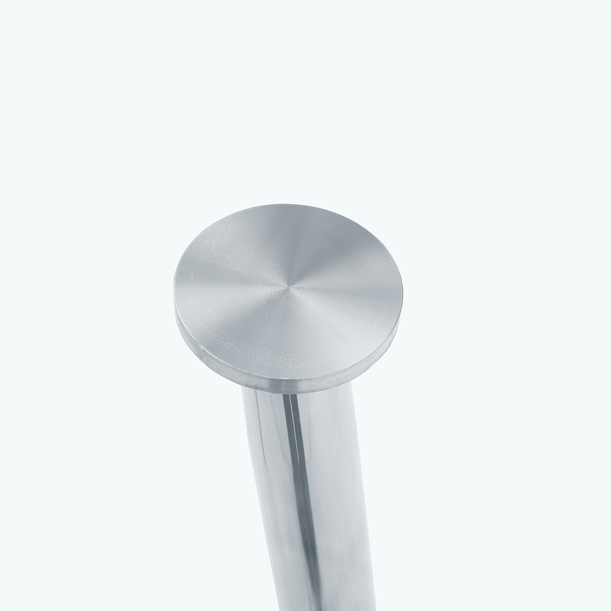 Studio close-up of a brushed metal suction-cup top on a chrome table leg